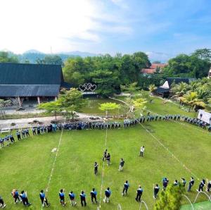 grupa ludzi stojących na polu w obiekcie GRAND MULYA HOTEL BOGOR w mieście Sukaraja