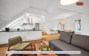 a living room with a couch and a kitchen at Budget Living in the outskirts of Zurich in Dietikon