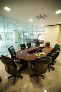 una sala de conferencias con una gran mesa de madera y sillas en Capitol Residence, en Vientiane