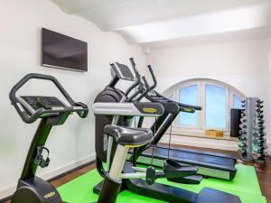 a gym with two treadmills and a treadmill at Ibis Styles Trier City in Trier