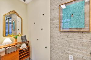 a bedroom with a brick wall and a mirror at Hotel Palace Gyeongju in Gyeongju