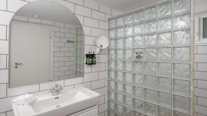 a bathroom with a sink and a mirror at Fairview Hotel Nairobi in Nairobi