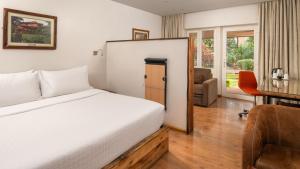 a hotel room with a bed and a desk at Fairview Hotel Nairobi in Nairobi