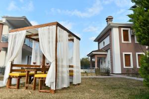 un cenador de madera en el patio trasero de una casa en Pak Family Villas, en Antalya