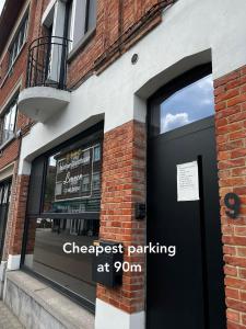 a store front with a black door and a sign on it at Escape in Leuven - self check in in Leuven