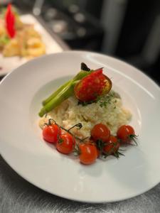 a plate of food with vegetables on a table at Hotel Hinrichs in Carolinensiel