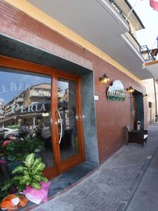 a window of a restaurant with a sign on it at Albergo La Perla in Orbetello