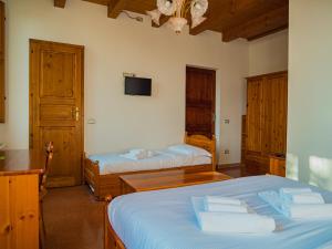 a bedroom with two beds and a tv on the wall at B&B Villa Erika in Villa San Martino