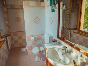 a bathroom with a sink and a toilet and a mirror at B&B Villa Erika in Villa San Martino