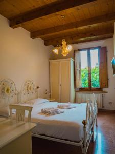 a bedroom with a white bed and a window at B&B Villa Erika in Villa San Martino