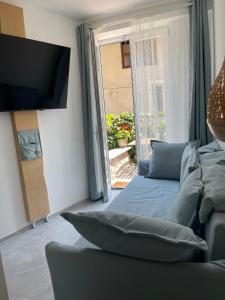 un soggiorno con letto, TV e finestra di B&B Casa Limone a Limone sul Garda