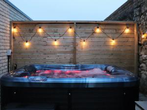 a hot tub with a person in it with lights at Jollys in Sandown