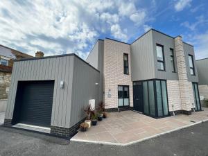 a large brick house with a garage at Jollys in Sandown