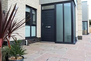 a black door on the side of a house at Jollys in Sandown