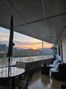 a patio with a table and chairs and a view at Vistadouro in Peso da Régua