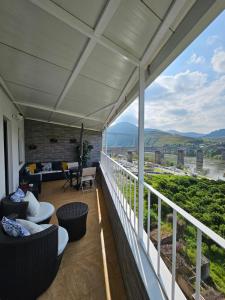 a balcony with chairs and a view of the river at Vistadouro in Peso da Régua