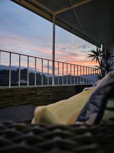 a bed on a balcony with a view of the sunset at Vistadouro in Peso da Régua