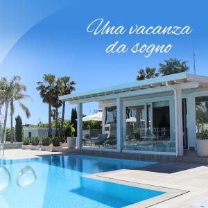 a swimming pool in front of a villazonaemiaemiaemiaemiaemiaemia at Female Resort in San Felice Circeo