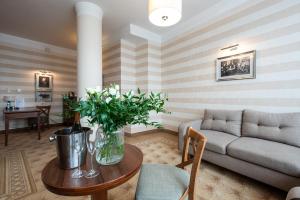 a living room with a couch and a table at Hotel Esperanto in Białystok