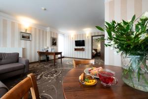 a living room with a table with food on it at Hotel Esperanto in Białystok