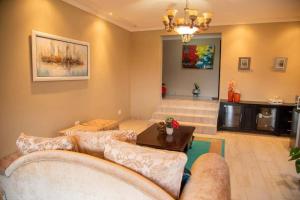 a living room with a couch and a table at Gorge View. in Mbabane