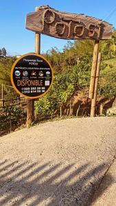 um sinal no lado de uma estrada de terra batida em Hospedaje Rural POTOSI em El Peñol