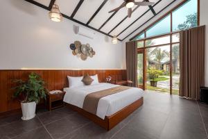 Ліжко або ліжка в номері La Vento Resort Ninh Bình