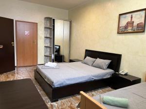 a bedroom with a large bed and a room with at Mini Hotel Smak in Dnipro