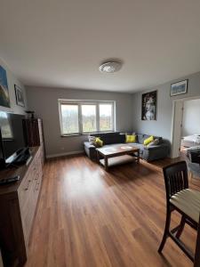 a living room with a couch and a table at Apartament nr 1 Chorzelów in Mielec