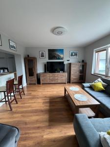 a living room with a couch and a table at Apartament nr 1 Chorzelów in Mielec