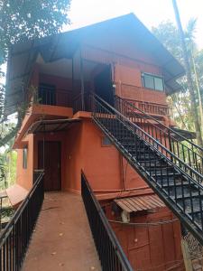 a building with a staircase in front of it at Ayurguru Ayurvedic Kalari Resort in Sultan Bathery