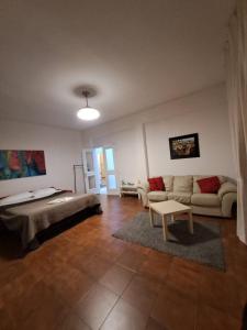 a living room with a couch and a table at Rome Apartment D'Amata in Ciampino