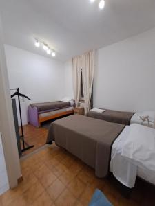 a bedroom with two beds and a tv in it at Rome Apartment D'Amata in Ciampino