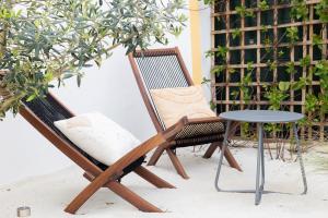 a pair of chairs and a table on a patio at Casa Idalia Boutique Hotel in Comporta