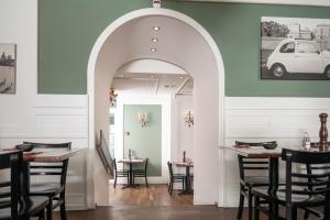 an archway in a restaurant with tables and chairs at Boutique Hotel Weisses Kreuz - Adult only Hotel in Luzern