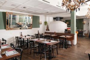 a dining room with wooden tables and chairs at Boutique Hotel Weisses Kreuz - Adult only Hotel in Luzern