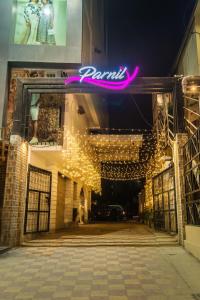 a building with a pink neon sign on it at Parnil Palace in Guwahati