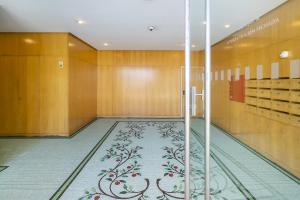 a hallway with a tile floor and wooden walls at Luxury Living by the Sea Matosinhos Marvel in Matosinhos