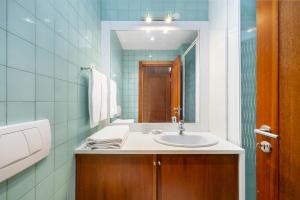 a bathroom with a sink and a mirror at Luxury Living by the Sea Matosinhos Marvel in Matosinhos