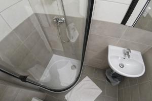 a bathroom with a shower and a sink at Penzion Tenis Klub DEZA in Valašské Meziříčí