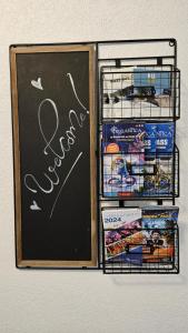 a refrigerator with a chalk board and some food at Gästehaus Ferienwohnung Abendstern in Rust