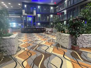 a large lobby with a floor with plants on it at Studio 6 Suites Amarillo, TX West Medical Center in Amarillo