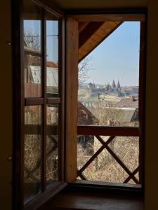 an open window with a view of a city at Tisnyi 7 Guest House in Kamianets-Podilskyi