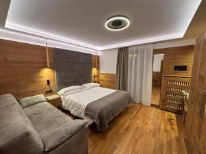 A bed or beds in a room at Alexander Hotel Alpine Wellness Dolomites