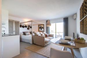 a kitchen and living room with a couch and a table at Victoria Sunset Suites in San Antonio