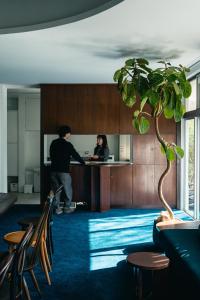 un homme et une femme debout à un bureau dans un bureau dans l'établissement koti hakone（コティ箱根）, à Hakone