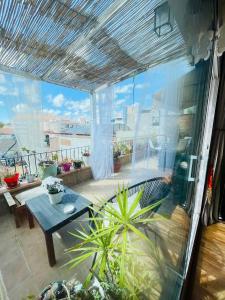 a balcony with a table and a view of a patio at Sweet Atic in Sitges