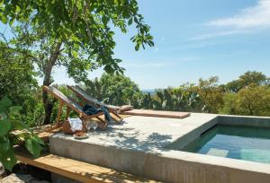 a hammock and a swimming pool in a backyard at Vigias -Eternal Landscapes in Marvão