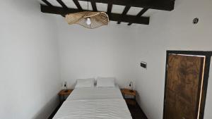 a white room with a bed and a chandelier at La Merced in Salta