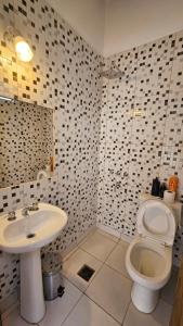 a bathroom with a toilet and a sink at La Merced in Salta